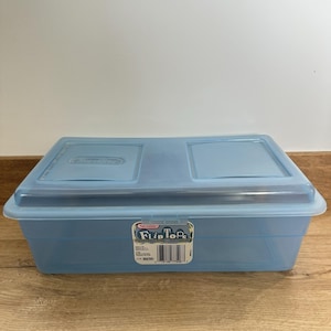 May include: A light blue Sterilite Flip Top storage container. The container has a clear lid with two flip-top sections. The label on the front reads "Sterilite Flip Tops" and includes a barcode.
