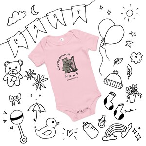 May include: A pale pink baby bodysuit featuring the words "Hippopotamus Harp" and a cartoon hippo playing a harp. The image is surrounded by hand-drawn illustrations of baby-related items, including a banner that says "BABY".