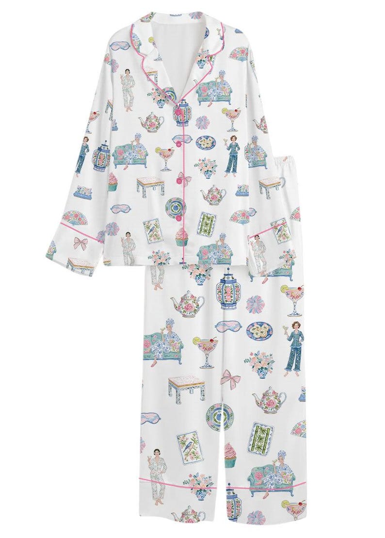 May include: A white long-sleeve pajama set with a button-down top and matching pants. The fabric features a colorful repeating print of teapots, cocktails, floral arrangements, decorative vases, small tables, and figures lounging on sofas.