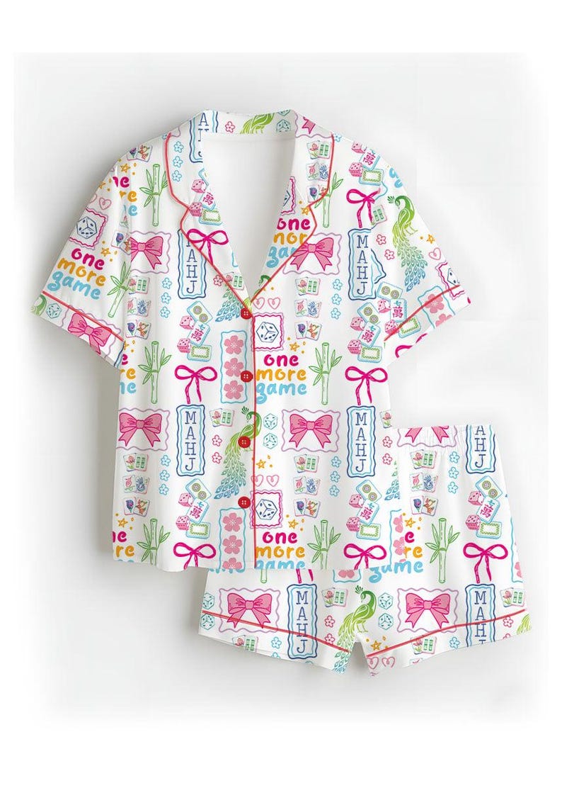 May include: A white short-sleeve pajama set with red piping, featuring a repeating pattern of pink bows, green bamboo, peacocks, dice, and mahjong tiles. The text "one more game" and "MAHJ" is printed throughout the shirt and shorts in various colors.