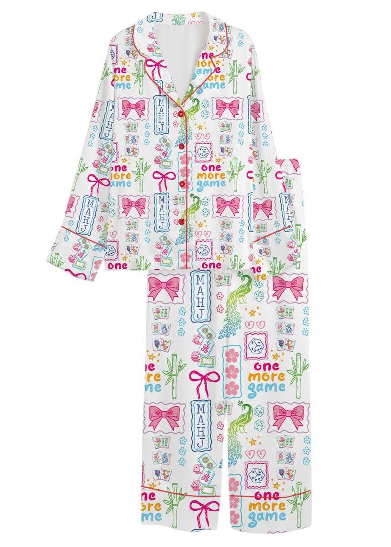 May include: A white long-sleeve pajama set with a button-down top and matching pants. The fabric features a colorful pattern of pink bows, green bamboo stalks, green peacocks, dice, and the text "one more game" and "MAHJ" in various colors.
