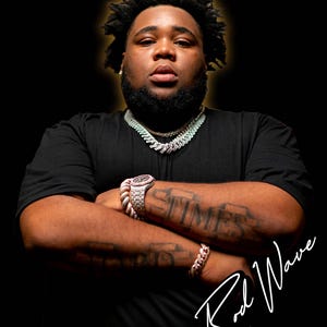 May include: A portrait of Rod Wave against a black background. He wears a black t-shirt, a diamond chain, a diamond bracelet, and a diamond watch. His arms are crossed, and he has tattoos on his forearms. The image includes the text "Rod Wave".