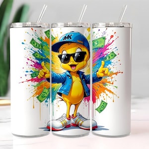 May include: White stainless steel tumbler with a cartoon image of a yellow chick wearing sunglasses, a blue jacket, and a blue cap. The chick is surrounded by colorful paint splatters and dollar bills. The tumbler has a silver lid and a clear straw.