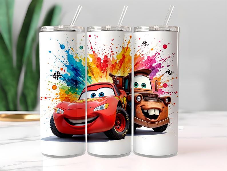 May include: Three white stainless steel tumblers with lids and straws. Each tumbler features a colourful design of characters from the movie Cars, with a vibrant splash of paint in the background. The tumblers are designed for cold beverages.