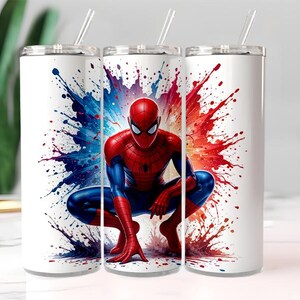 May include: White stainless steel tumblers with a Spider-Man design. The superhero is shown crouching against a backdrop of red, blue, and purple paint splatters. Each tumbler has a silver lid and a clear straw.