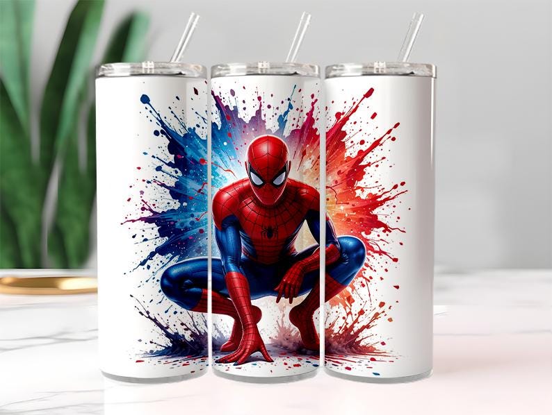 May include: White stainless steel tumblers with a Spider-Man design. The superhero is shown crouching against a backdrop of red, blue, and purple paint splatters. Each tumbler has a silver lid and a clear straw.