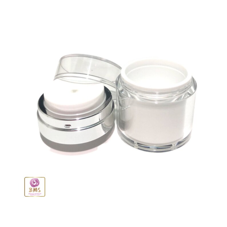 May include: A clear plastic jar with a silver lid and a white inner lid. The jar is empty and ready to be filled with a product.
