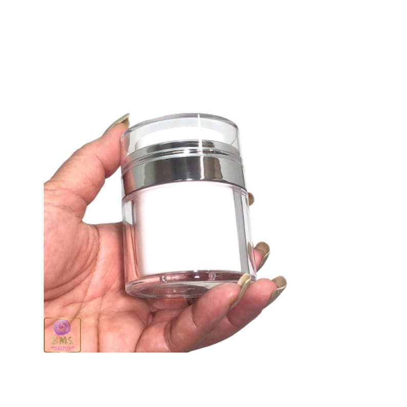 May include: A clear plastic jar with a silver pump top. The jar is empty and has a white label.