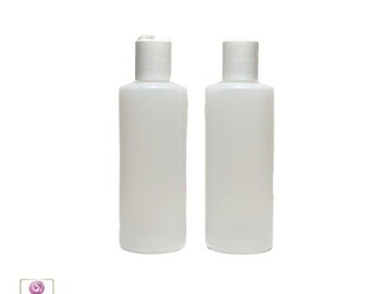 May include: Two white plastic bottles with flip top caps. The bottles are empty and ready to be filled.