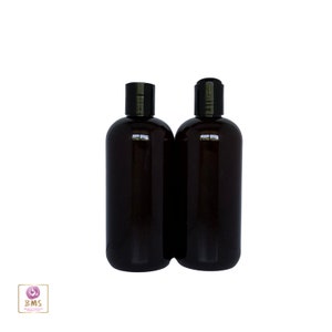 May include: Two amber glass bottles with black pump tops. The bottles are empty and ready to be filled with your favorite liquid.
