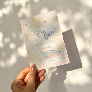 An elegant and fun bachelorette party invitation with a pink stripe background and yellow, salmon and blue brush and bold style text. Featuring lemons and hearts illustrations.