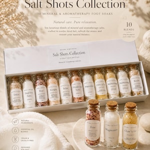 May include: A Salt Shots Collection set featuring ten glass bottles of mineral and aromatherapy foot soaks in a white box. Each bottle has a cork stopper and a label with names like Detox, Dead Sea Salts, Rose, Energise, Relax, Himalayan Salts, Magnesium, Glow 'n Go, and Moisturising.