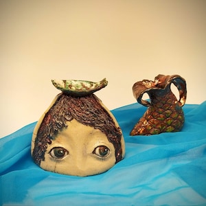 Mermaid, ceramic composition handmade. Ceramic vase in the shape of a mermaid using raku technique. Ceramic art.