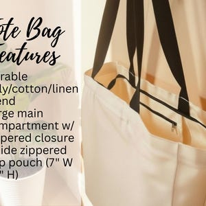 May include: Cream-colored tote bag with black straps, featuring a zippered closure and an inside zippered flap pouch. The text on the image reads "Tote Bag Features" and lists the bag's durable poly/cotton/linen blend and large main compartment.