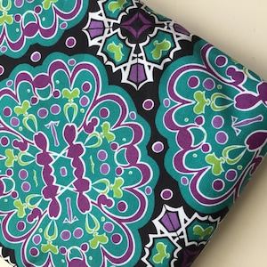 May include: Teal, purple, and white patterned fabric with a repeating design of stylized flowers and geometric shapes on a black background.