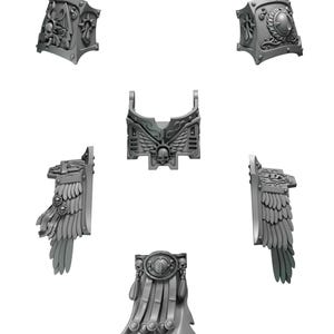 Op de afbeelding: Een verzameling grijze, 3D-geprinte miniatuur pantseronderdelen, waaronder schouderstukken, een borstplaat met een schedel- en vleugelontwerp en een decoratieve cape. De onderdelen zijn ingewikkeld gedetailleerd en ontworpen voor tabletop gaming of modelbouw.