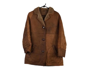 May include: A brown coat with a textured finish, featuring a notched collar lined with brown faux fur, long sleeves with wide cuffs, and a front button closure with three dark brown buttons. Two large patch pockets are visible on the front.
