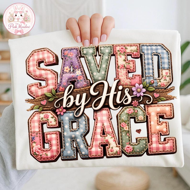 May include: White t-shirt with the text "SAVED by His GRACE" in a patchwork style. The letters are decorated with floral, gingham, and polka dot patterns. A floral and twig design is placed below the text.