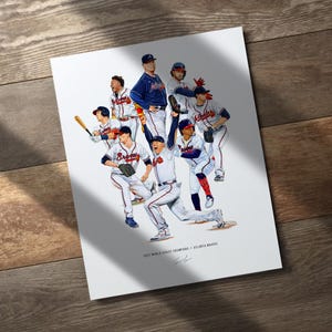 May include: A print featuring a team of baseball players in their uniforms. The players are in various action poses, with some holding bats and others celebrating. The print includes the text "2021 World Series Champions Atlanta Braves".