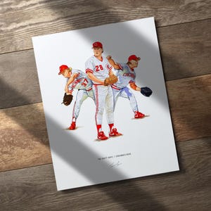 May include: A print featuring three baseball players in red and white uniforms, with the text "THE NASTY BOYS // CINCINNATI REDS". The players are in action poses, wearing red caps and shoes, and holding gloves.