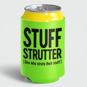 May include: A green can cooler with the words "STUFF STRUTTER" in large black letters. Below the text is the phrase "[One who struts their stuff]" in smaller black letters. The top of the can is yellow and the can itself is silver.