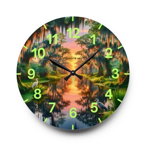 Mossy Bayou Sunset Acrylic Wall Clock | Swamp Herons, Spanish Moss

Floating sunlight slips between cypress trunks as herons stand watch — this acrylic wall clock brings a quiet bayou morning into your room. Lightweight yet sturdy, the glossy print keeps colors rich so the sunrise and moss-draped branches glow against the clock face.