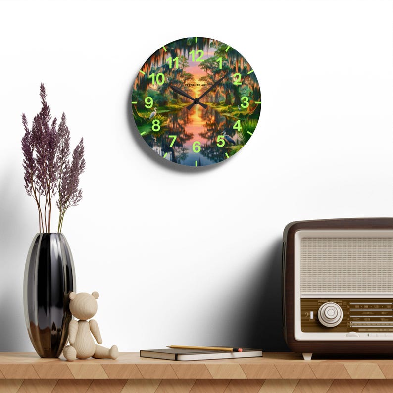 Mossy Bayou Sunset Acrylic Wall Clock | Swamp Herons, Spanish Moss

Floating sunlight slips between cypress trunks as herons stand watch — this acrylic wall clock brings a quiet bayou morning into your room. Lightweight yet sturdy, the glossy print keeps colors rich so the sunrise and moss-draped branches glow against the clock face.