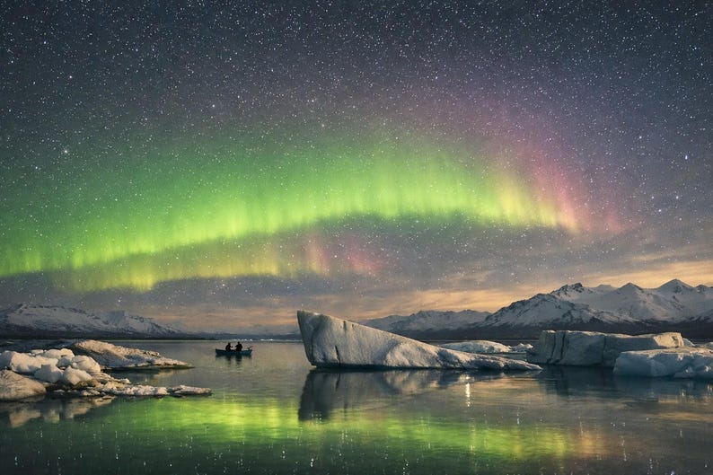24-048 | Aurora Borealis Art, Reflections, Stargazers on the Ice, Northern Lights Print, Nature photography (Digital Download)

Experience the wonder of the northern lights with Aurora Reflections, a breathtaking fine‑art print capturing two stargazers adrift beneath a glowing Arctic sky. This Aurora Borealis scene blends vivid greens, soft pinks, and pale yellows reflected in still glacial waters — a moment of serenity and awe.
