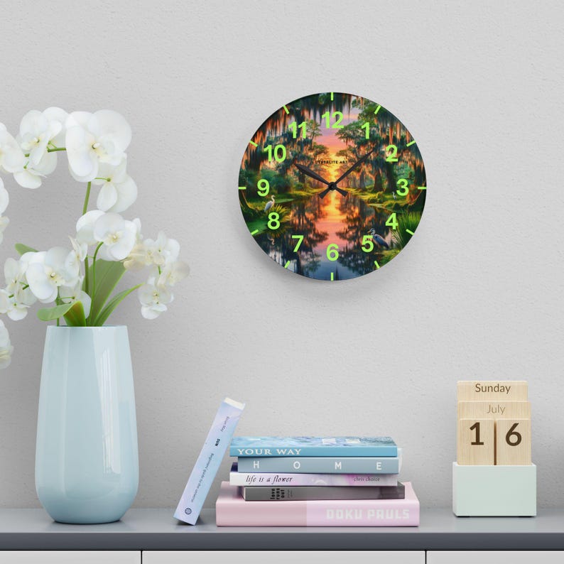 Mossy Bayou Sunset Acrylic Wall Clock | Swamp Herons, Spanish Moss

Floating sunlight slips between cypress trunks as herons stand watch — this acrylic wall clock brings a quiet bayou morning into your room. Lightweight yet sturdy, the glossy print keeps colors rich so the sunrise and moss-draped branches glow against the clock face.