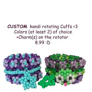 May include: Two custom kandi rotating cuffs. One cuff is purple, light blue, and lavender. The other cuff is green, black, and purple. The cuffs have charms on the rotator. The text on the image says "CUSTOM kandi rotating Cuffs <3 Colors (at least 2) of choice +Charm(s) on the rotator".