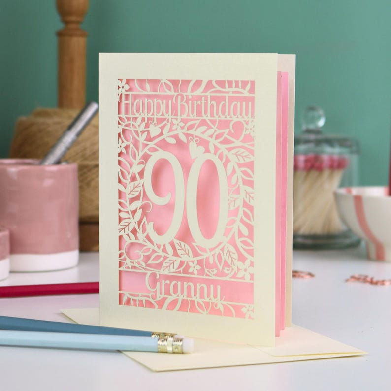 A cream laser cut 90th birthday card with decorative '90' in the centre, 'Happy Birthday' above, and personalised with the name of the recipient underneath.