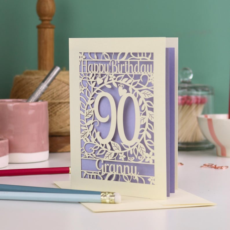 A cream laser cut 90th birthday card with decorative '90' in the centre, 'Happy Birthday' above, and personalised with the name of the recipient underneath.