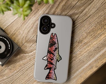 May include: A light gray phone case featuring a stylized fish design in red, black, and yellow. The fish illustration has a black outline and is centered on the case. The phone case is on a wooden surface.