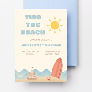 May include: A beach-themed invitation with the text "TWO THE BEACH" and a yellow sun illustration. The invitation includes details for Jackson's 2nd birthday, a sandcastle, and a surfboard. A light blue envelope is behind the invitation.