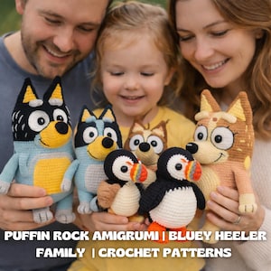 May include: A family holds a collection of handmade crochet amigurumi toys. The toys include Bluey Heeler and Bingo Heeler characters, along with two puffin figures. The toys are in various colors, including blue, yellow, brown, black, and white. Text on the image reads: Puffin Rock Amigurumi | Bluey Heeler Family | Crochet Patterns.