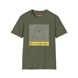 May include: An olive green t-shirt with a pixelated ghost design inside a rectangular frame. The text "DressCoder" is in yellow below the graphic. The shirt has a crew neck and short sleeves.