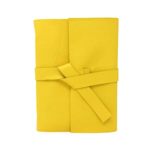 May include: A bright yellow leather journal with a matching leather tie closure.