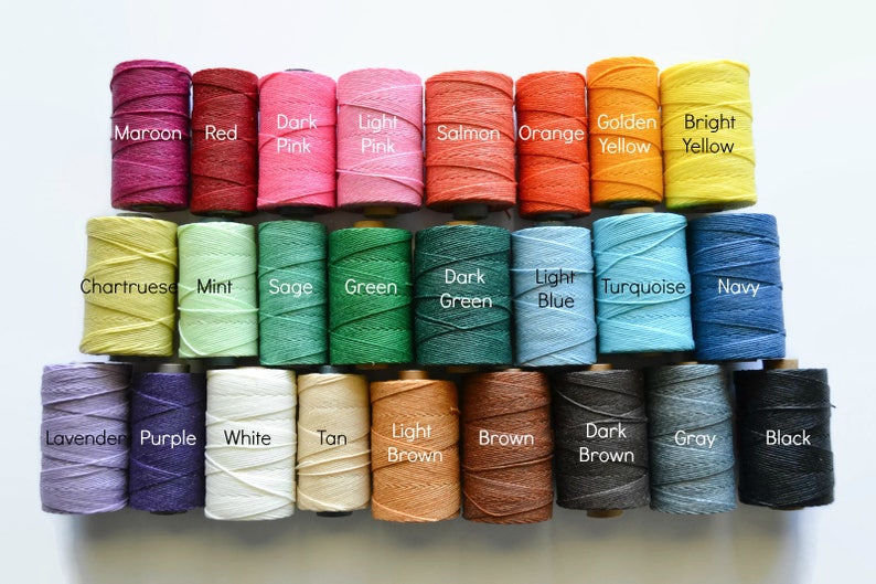 May include: A collection of 24 spools of thread in various colors, including maroon, red, dark pink, light pink, salmon, orange, golden yellow, bright yellow, chartreuse, mint, sage, green, dark green, light blue, turquoise, navy, lavender, purple, white, tan, light brown, brown, dark brown, gray, and black.