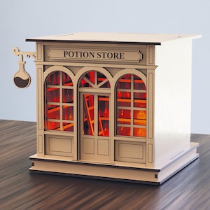 May include: A wooden model of a potion store with arched windows and a sign that reads "POTION STORE." The windows glow with an orange light, suggesting an interior scene. A hanging sign with a potion bottle is on the left.