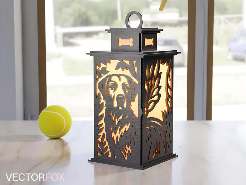 May include: A wooden lantern with a dog silhouette design. The lantern is dark gray with a light-colored interior, featuring a dog's face and bone-shaped cutouts. A yellow tennis ball sits nearby.