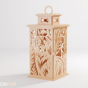 May include: A light-colored wooden lantern with a dog design cut out of the sides. The lantern has a rectangular shape with a top section featuring a handle and decorative cutouts. The dog's face is visible on the front panel.