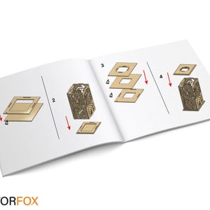 May include: Open book with assembly instructions for a decorative wooden lantern. The instructions show the steps to assemble the lantern, with diagrams and arrows. The lantern has an intricate design. The VectorFox logo is at the bottom.