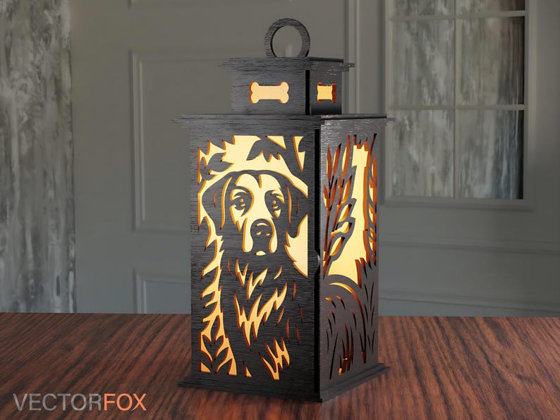 May include: A black wooden lantern with a dog portrait cutout design. The lantern features a handle, a bone-shaped cutout, and a rectangular shape. The dog's face is visible through the cutout, and the lantern is placed on a wooden surface.