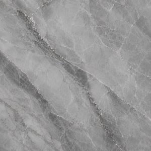 May include: A polished stone surface featuring a cool gray base color with intricate, darker gray veining patterns running diagonally across the slab. The texture displays a natural marble appearance with varying shades of light and dark gray tones.