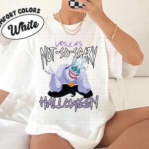 May include: White t-shirt with the text "URSULA'S NOT-SO-SCARY HALLOWEEN" and a cartoon illustration of Ursula from The Little Mermaid. The shirt also has the words "COMFORT COLORS" and "White" in a circle.