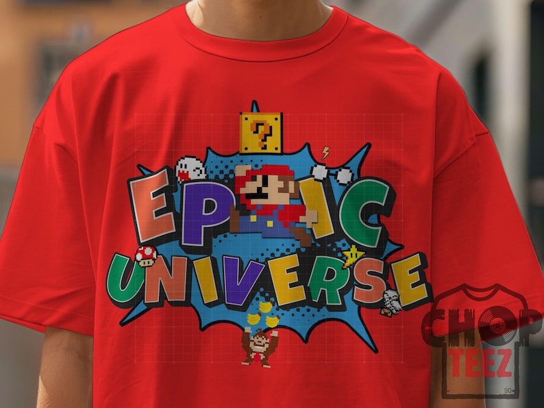 May include: Red t-shirt featuring a pixelated graphic with the words "EPIC UNIVERSE" in colorful letters. The design includes pixelated characters and elements from a popular video game, set against a blue burst background.