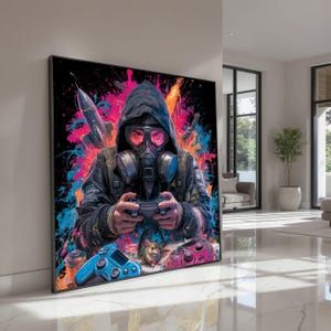 以下が含まれることがあります： ガス・マスクとフード付きジャケットを着た人物がビデオゲームをしている、額装されたアートプリント。 ピンク、青、オレンジ色のスプラッシュが施されたカラフルな背景。 青いゲームコントローラーが前景にあります。