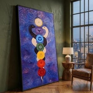 May include: A rectangular framed wall art piece featuring a vertical composition against a deep blue textured background. Two intertwined snakes, one black and one white, surround a central column of seven colourful circular chakra symbols.