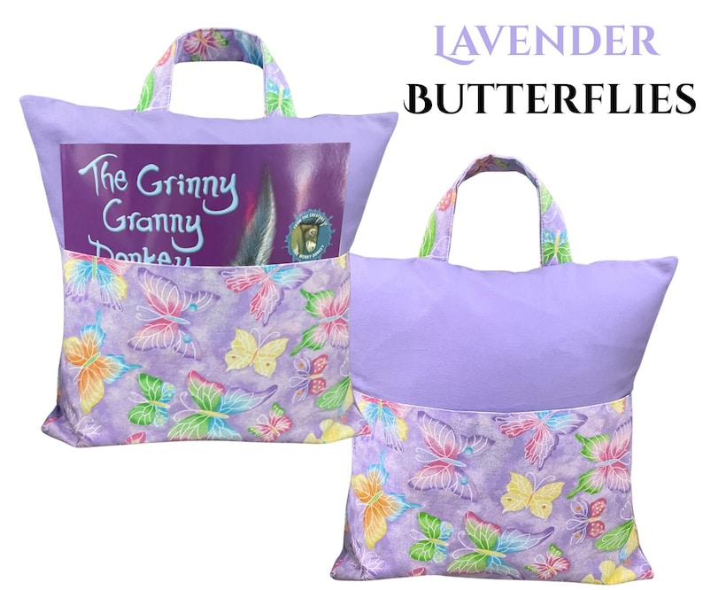 Puede incluir: Dos almohadas de lectura lavanda con asas. Las almohadas tienen un bolsillo con un estampado de mariposas y un libro titulado "The Grinny Granny Donkey" en el bolsillo. El texto "Lavender Butterflies" est&aacute; encima de las almohadas.
