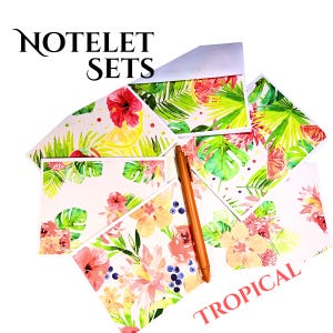 May include: A set of notelets featuring tropical floral and fruit watercolor patterns in shades of pink, yellow, and green, accompanied by a solid orange pen. The text NOTELET SETS and TROPICAL are printed on the image in a black and red font.